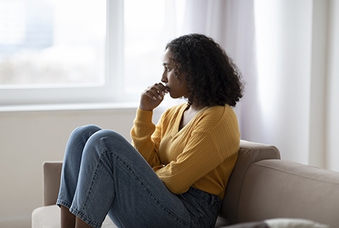Worried Woman sitting on couch