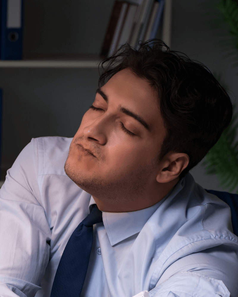 Business man with closed eyes, portraying effects of illicit drugs