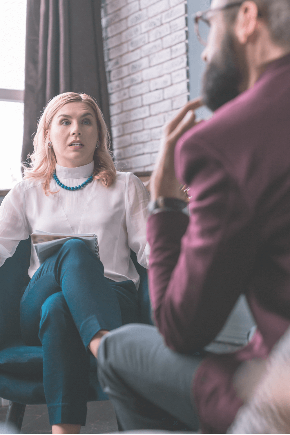 Therapist talking with her male patient