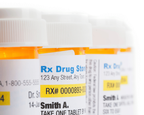 Prescription drug bottles portraying addiction and rehab treatment