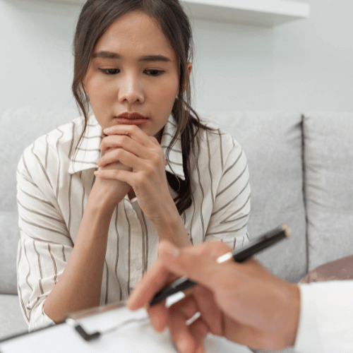 A young woman sits quietly during an assessment and discussion about benzodiazepine treatment cost