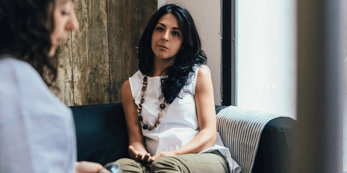 A client listens to her therapist at an addiction and mental health facility