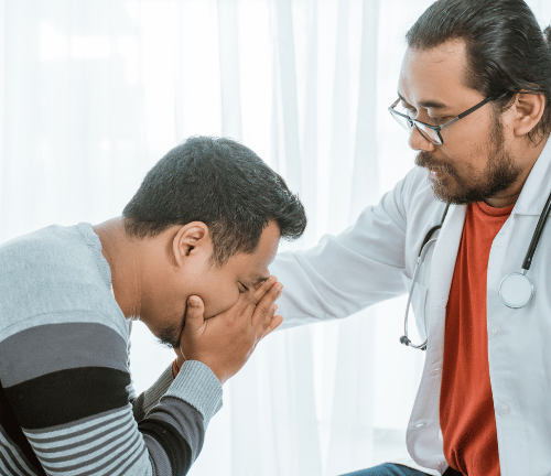 A physician's assistant talking to a man about prescription options for medication-assisted treatment